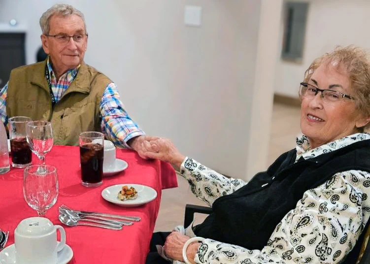 A couple sharing a meal and holding hands, from Aura’s community gallery